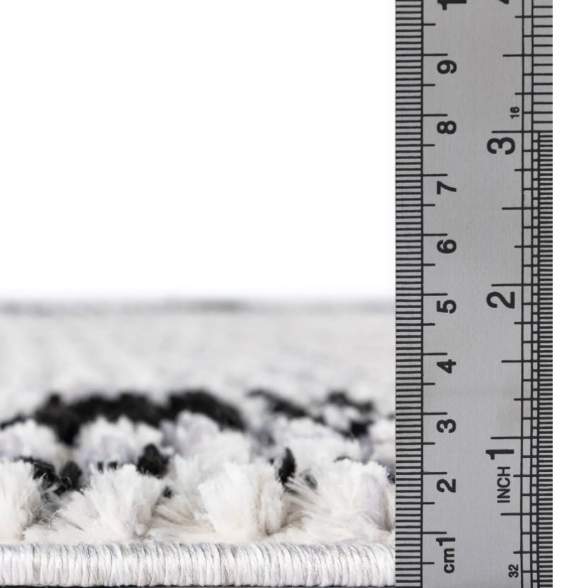 Close-up of a textured white surface with a ruler for scale