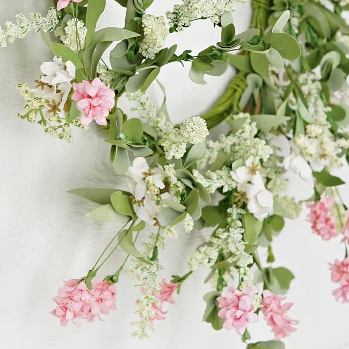 Floral wreath with pink and white flowers on a light background