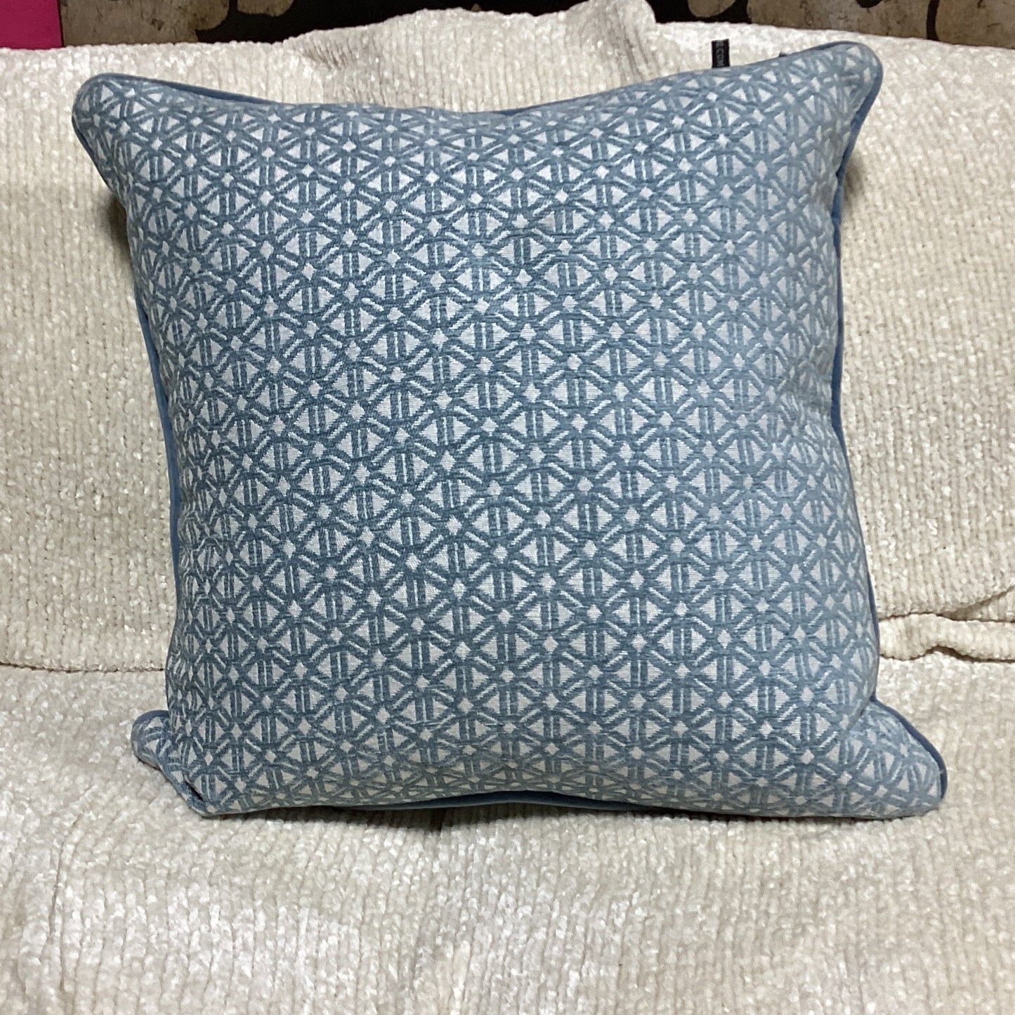 light blue and white decorative pillow