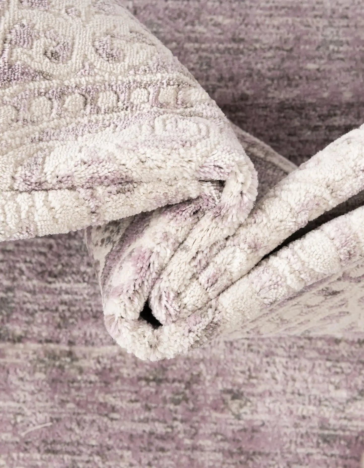 Close-up of a textured fabric roll on a wooden surface