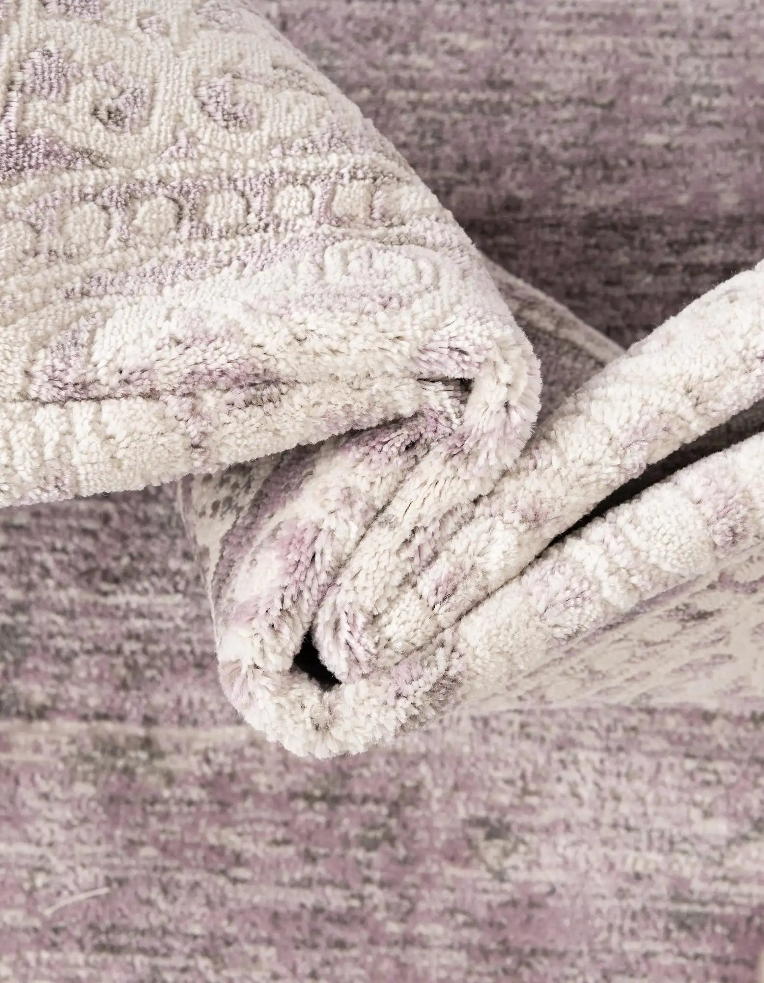 Close-up of a textured fabric roll on a wooden surface