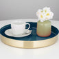 A blue and gold stainless steel serving tray with a cup of coffee and a vase with flowers on top of the tray.