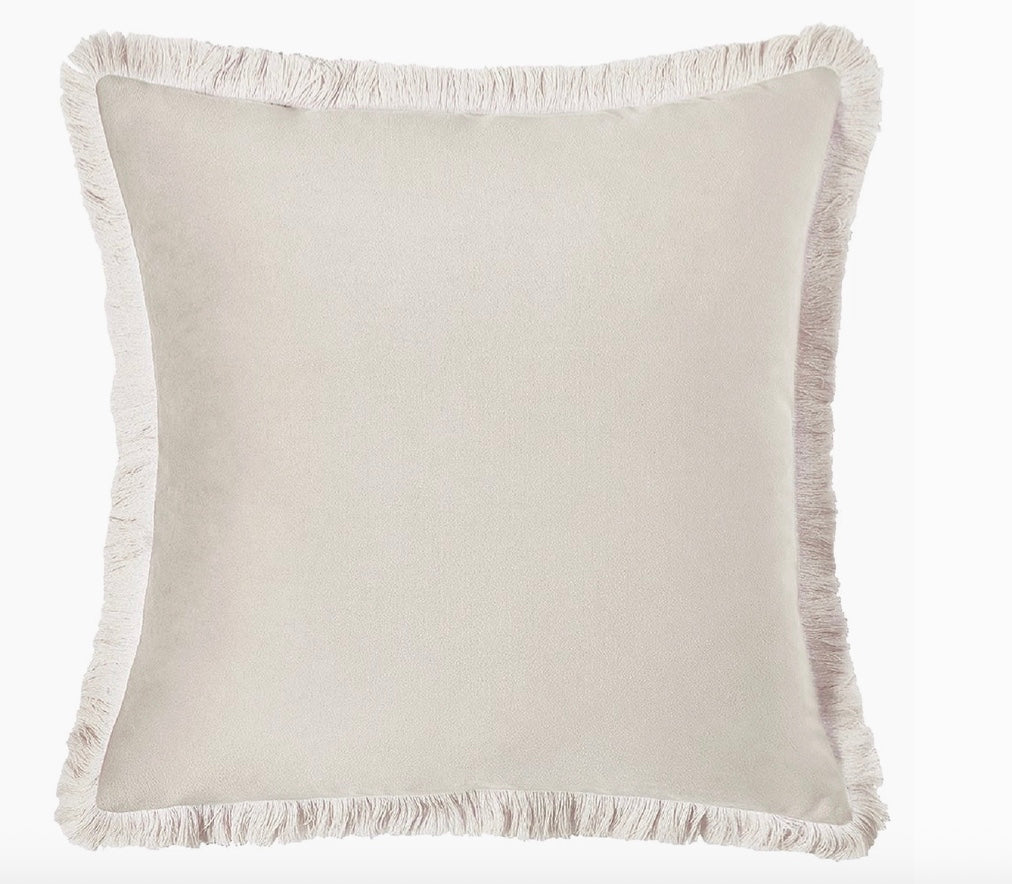 Beige pillow with frayed edge on a white background