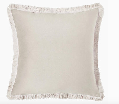 Beige pillow with frayed edge on a white background