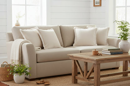 Beige pillow with frayed edge on a white background