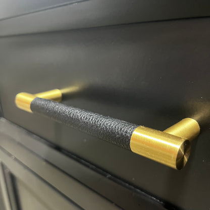 Black and gold handle on a black surface
