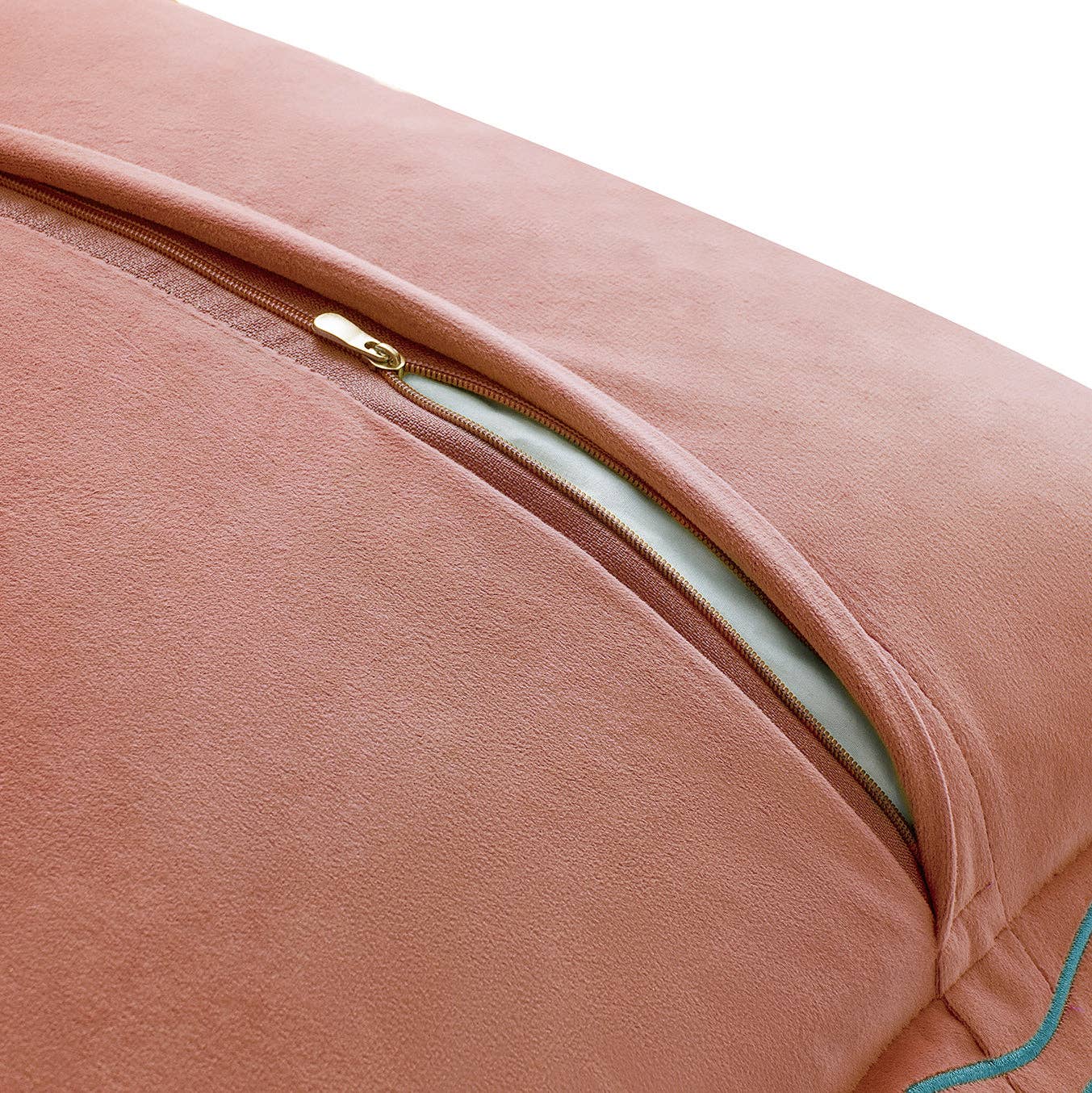 Close-up of a pink cushion with a zipper on a white background