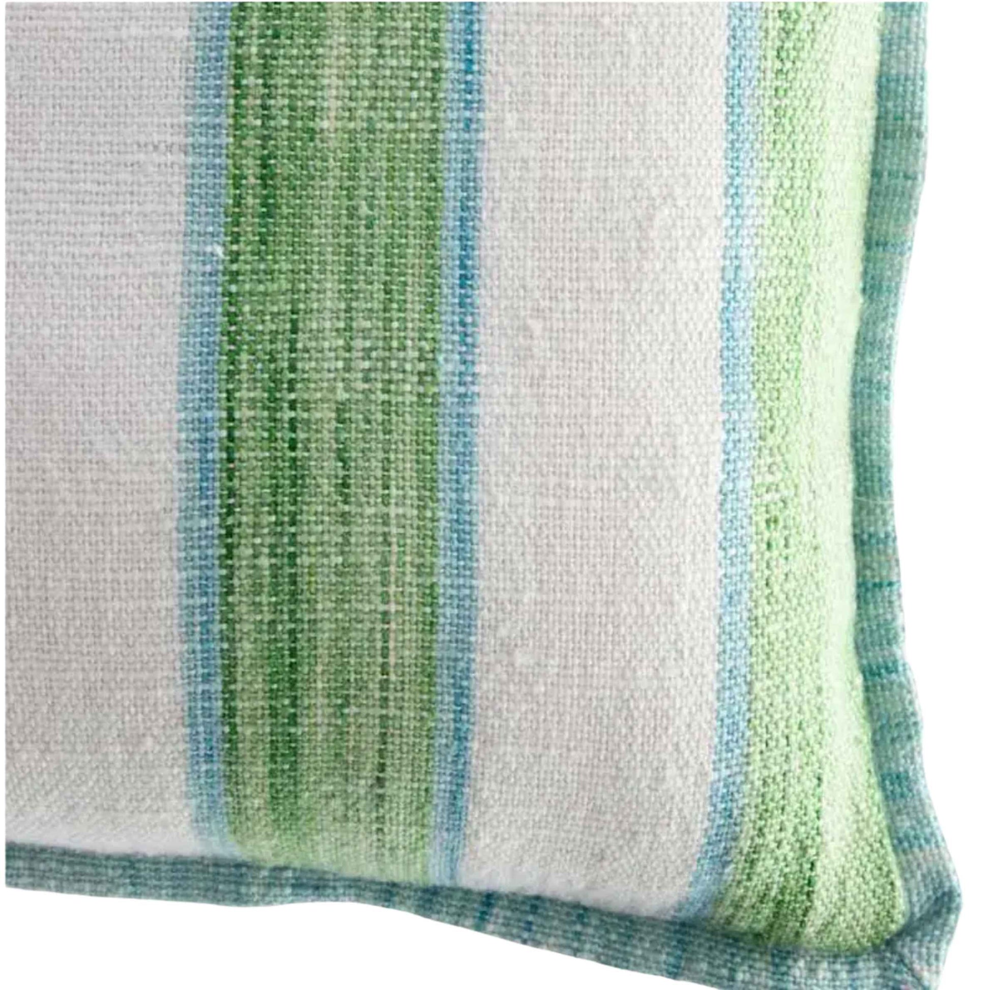 Close-up of a striped pillow with green, blue, and white colors.