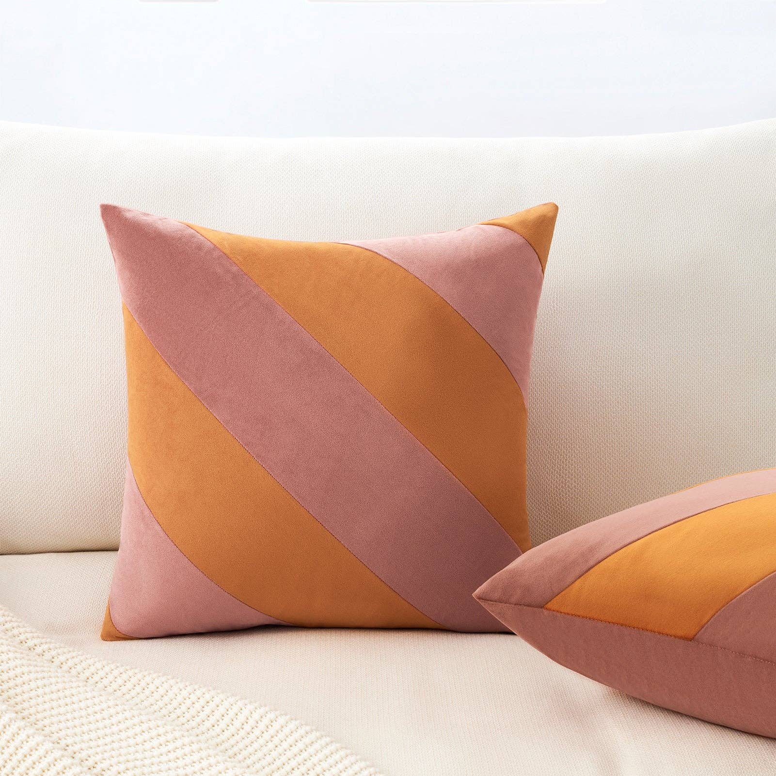 Colorful geometric-patterned pillows on a light-colored sofa.