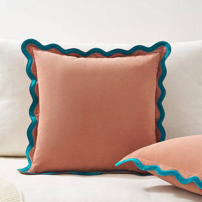 Cushion with blue scalloped edge on a white sofa