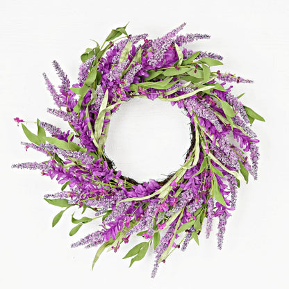 Floral wreath with purple flowers and green leaves on a white background