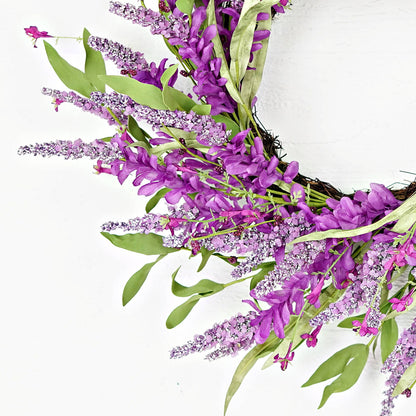 Decorative wreath with purple flowers and green leaves on a white background