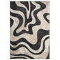 An area rug featuring an abstract, organic wavy pattern in black and beige with a distressed, textured finish.