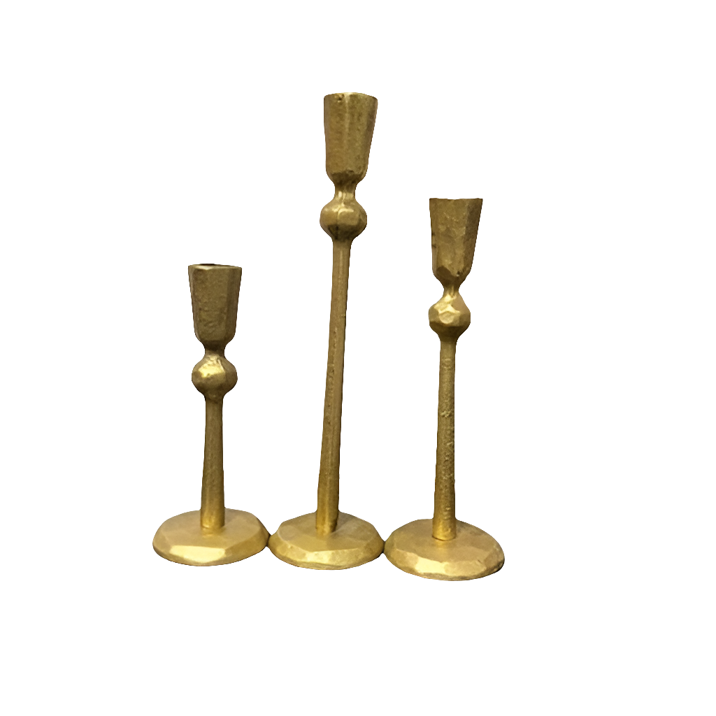 Three gold candle holders of different heights.