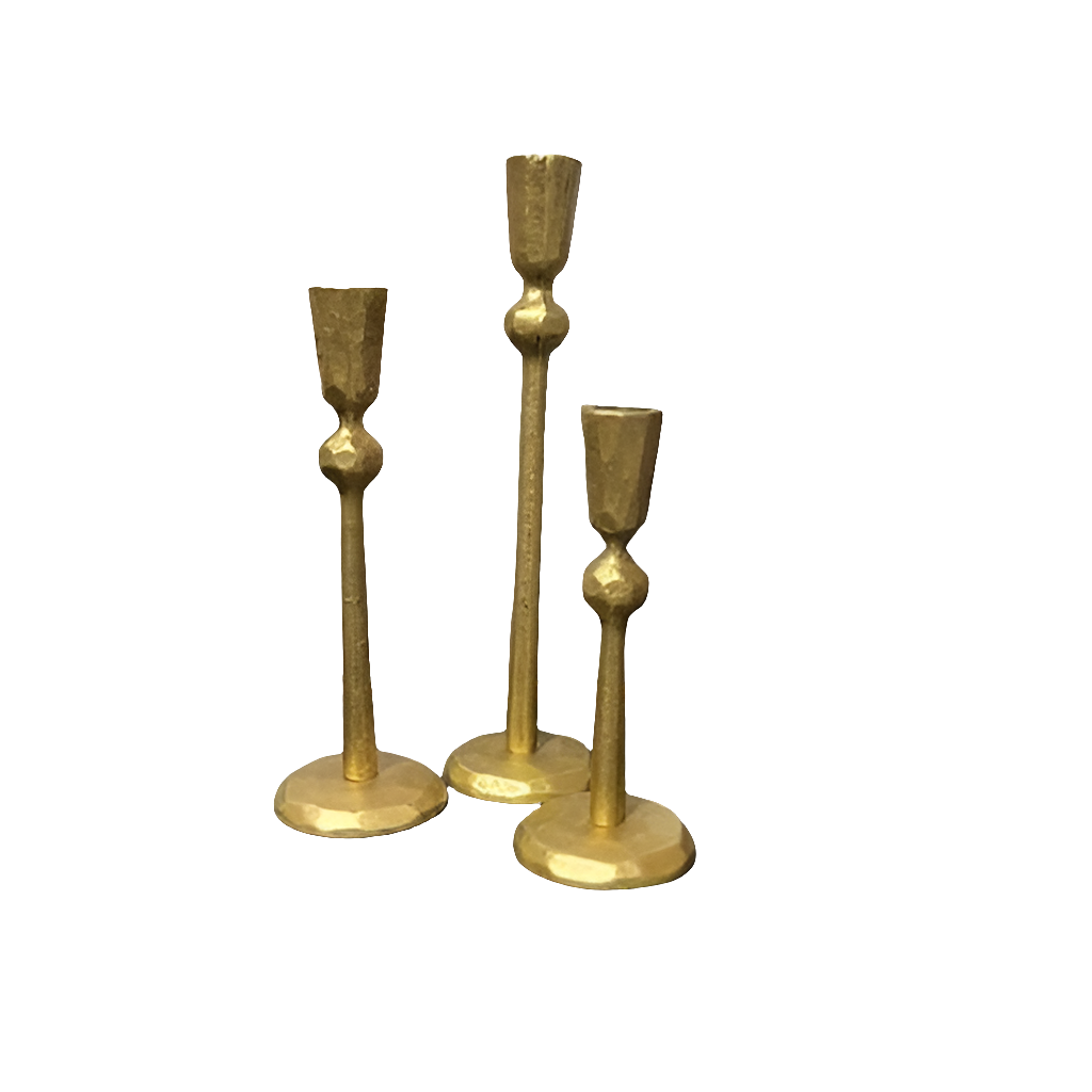 Three gold candle holders of varying heights.