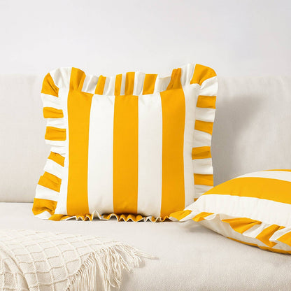 Yellow and white striped pillows on a light-colored couch.