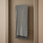 Gray throw blanket with tassels on a white background