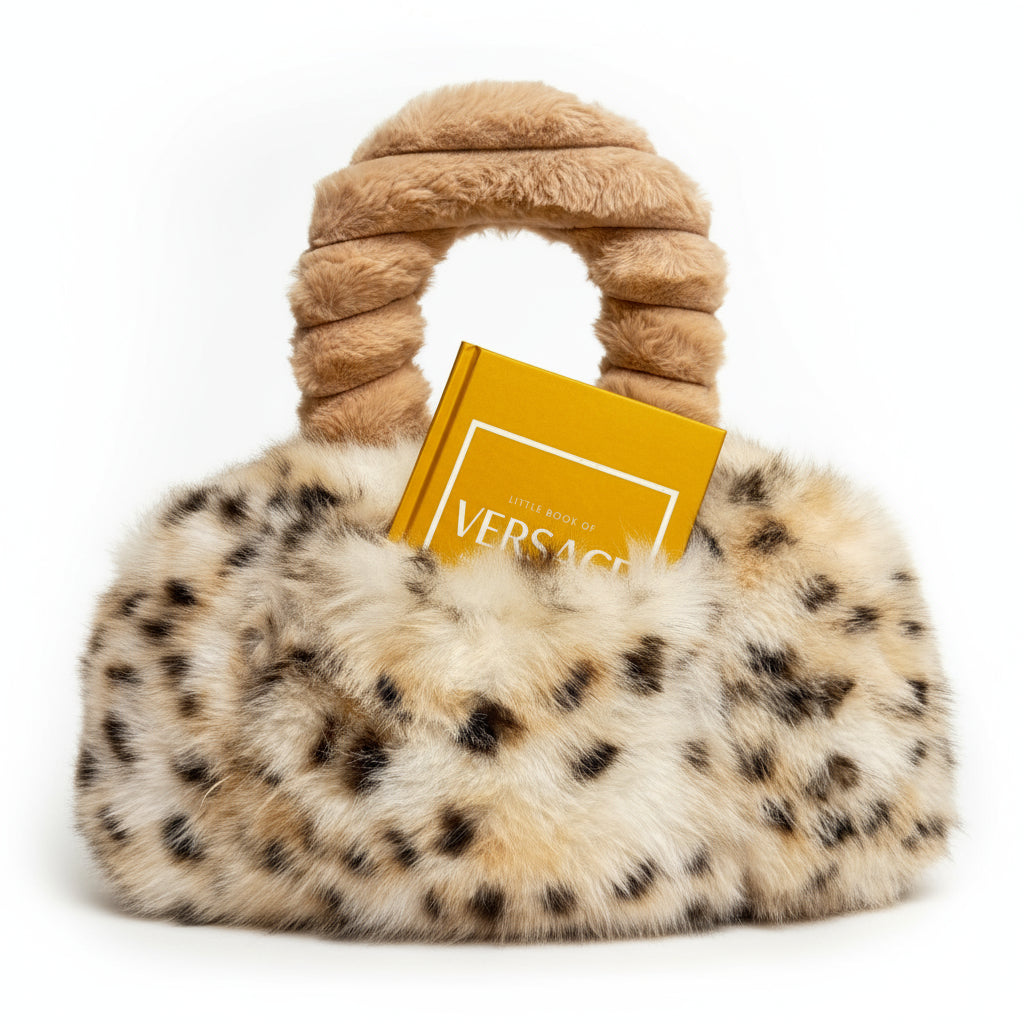 Leopard print handbag with a gold book titled 'Little Book of Versace' on a white background