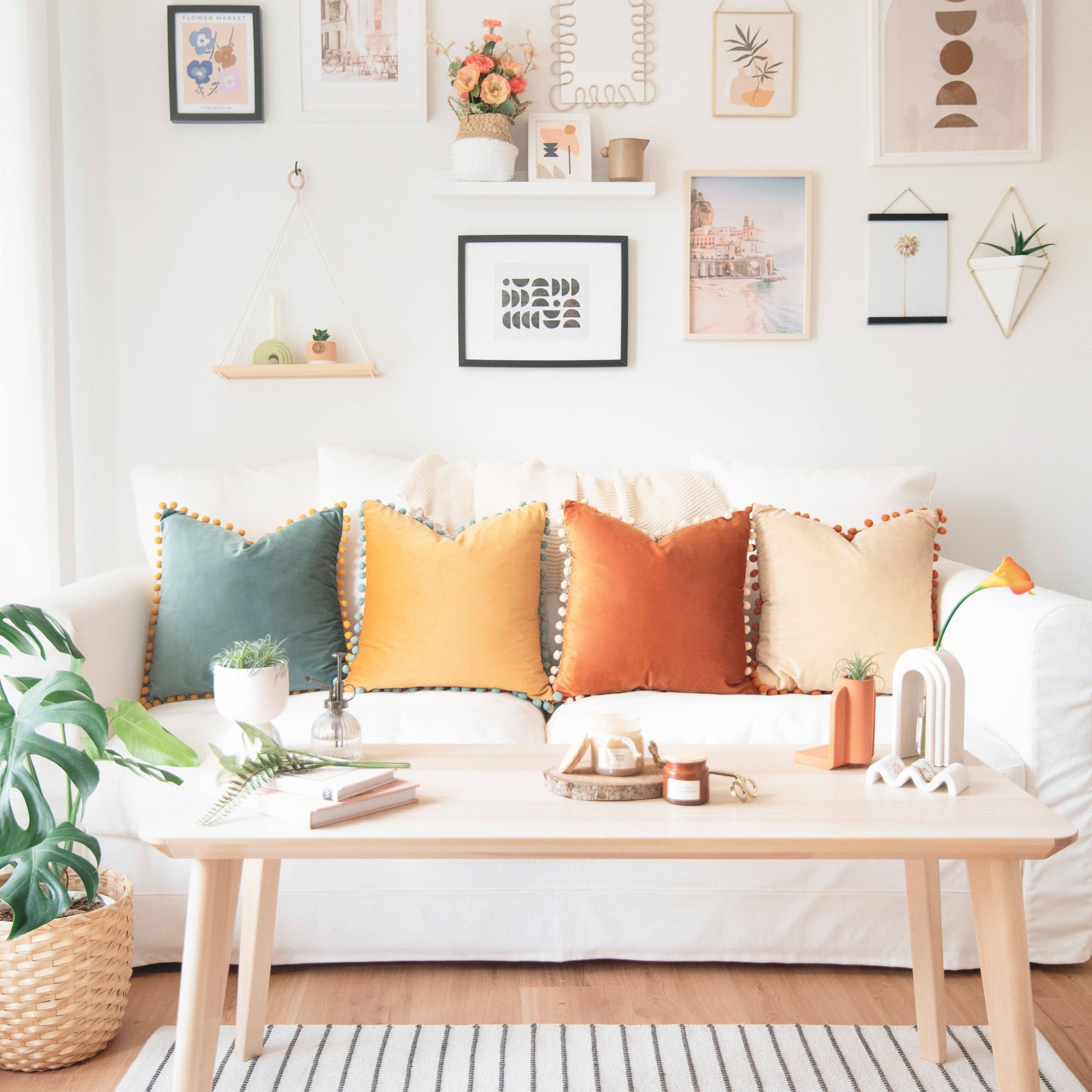 Living room with a white sofa, colorful pillows, and a wooden coffee table.