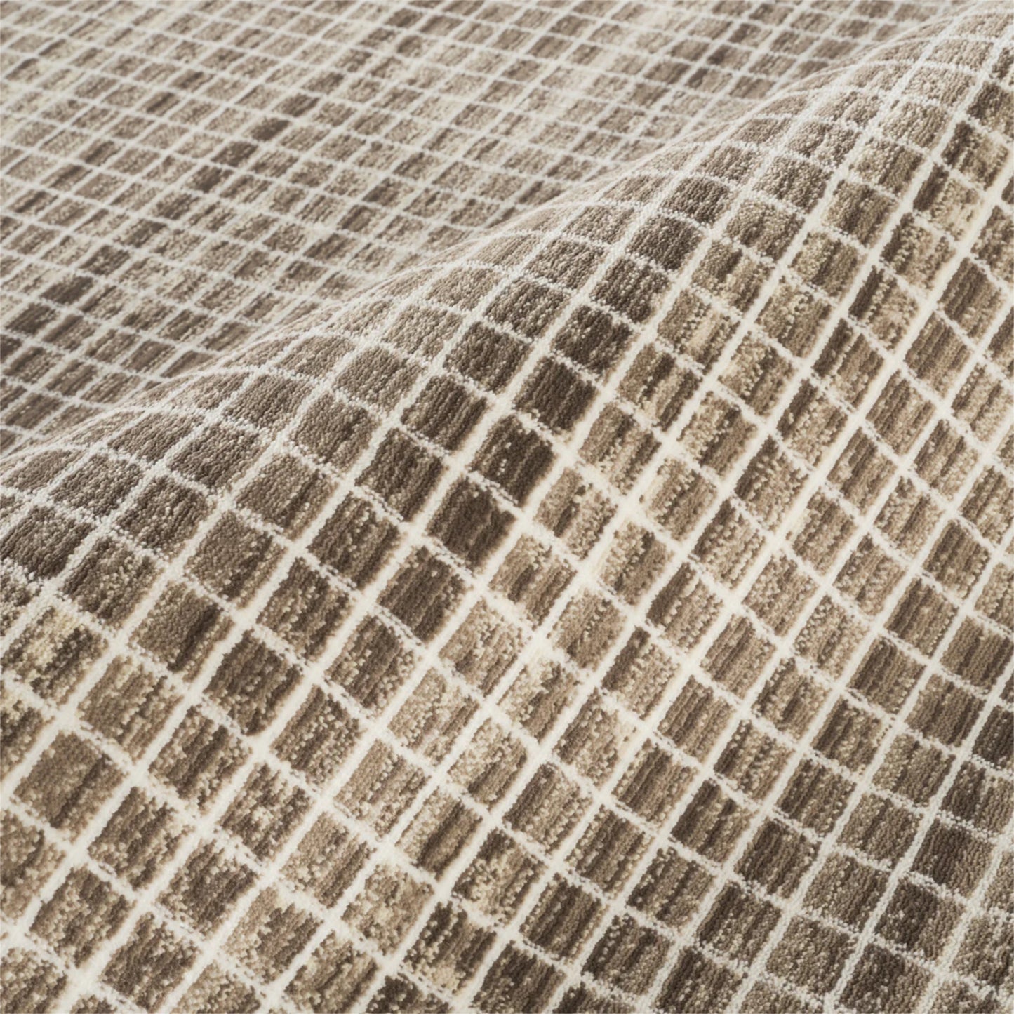 A close-up of a woven fabric with a textured grid pattern in brown and beige.