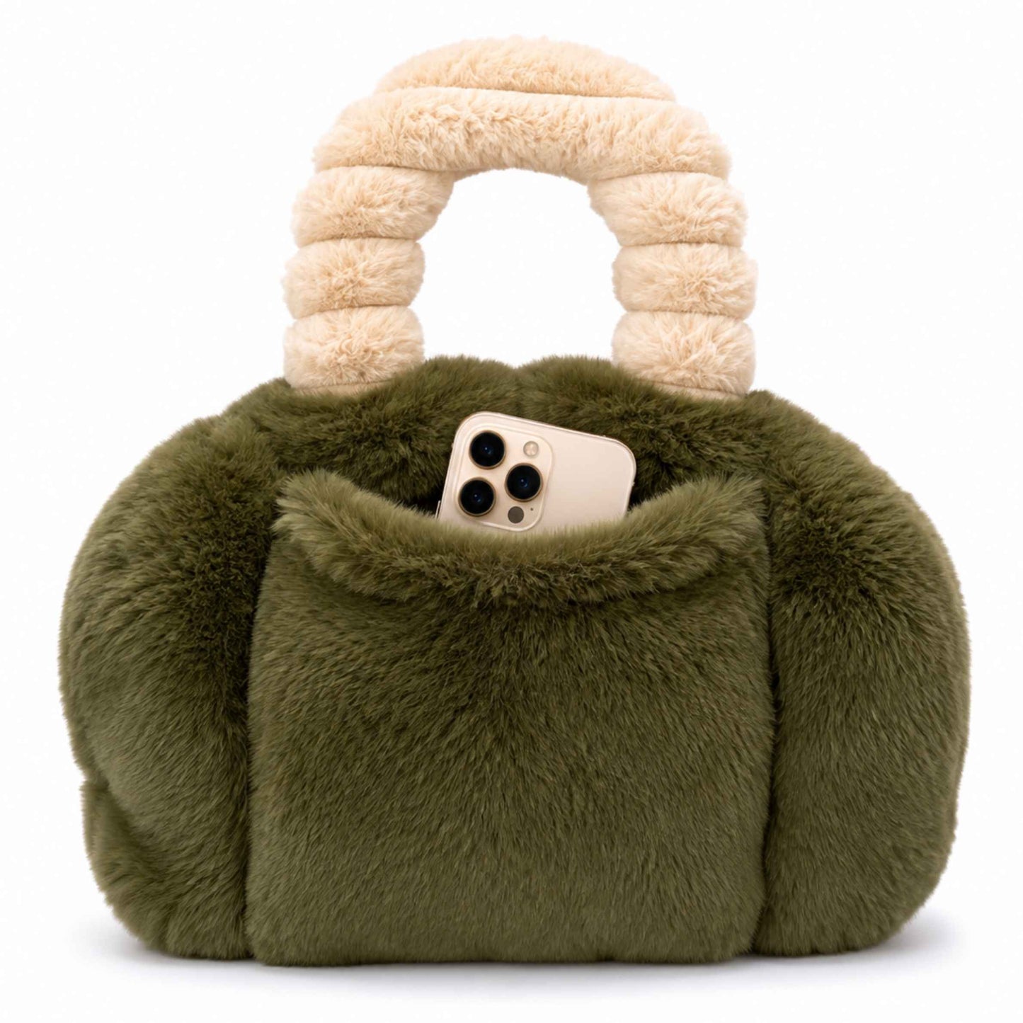 An moss green faux fur Pur-low with a chunky cream-colored handle, featuring a front pocket holding a smartphone, set against a plain white background.