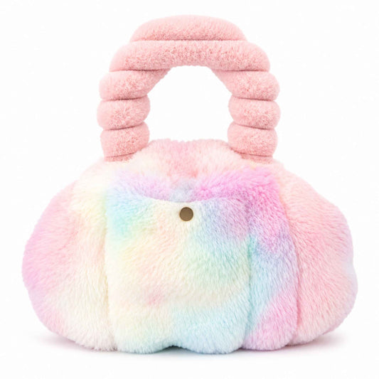 A fluffy rainbow Pur-Low with a rounded body, a small gold-tone front button, and a thick ribbed top handle. The bag has a soft tie-dye look blending pink, blue, yellow, and white, photographed on a clean white background.