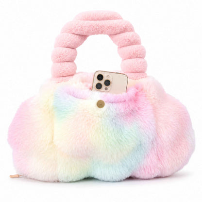 A fluffy pastel rainbow Pur-Low with a rounded body, a thick ribbed pink handle, and a small gold clasp, shown on a clean white background with a phone tucked inside the front pocket.