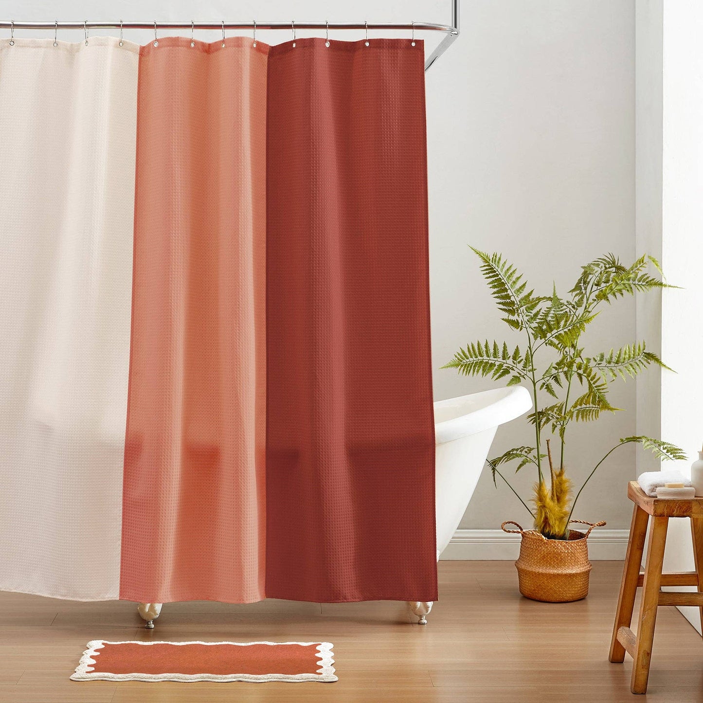 Reddish-brown shower curtain with a plant and stool in a bathroom setting