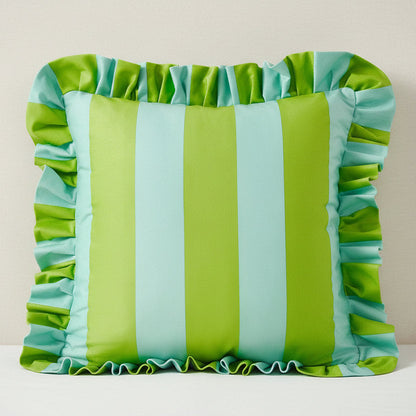 Striped pillow with ruffled edges in green and blue on a plain background