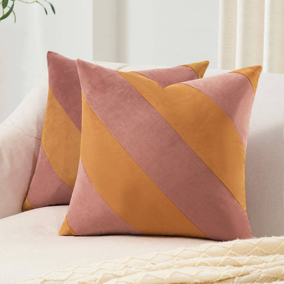 Two decorative pillows with a geometric pattern on a sofa.