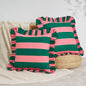 Two striped pillows with ruffled edges on a neutral background