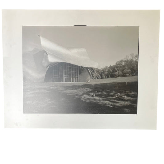 Black and white photograph of a modern building with a large dome-like structure.