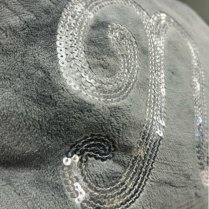 Silver sequin on a textured gray fabric background