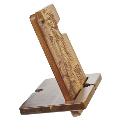 Wooden phone stand with engraved design on a white background