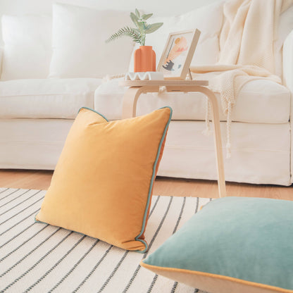 Yellow pillow on a striped rug with a white sofa and side table in the background