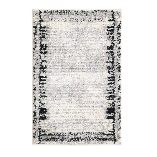 Rectangular area rug with a black and white pattern on a white background