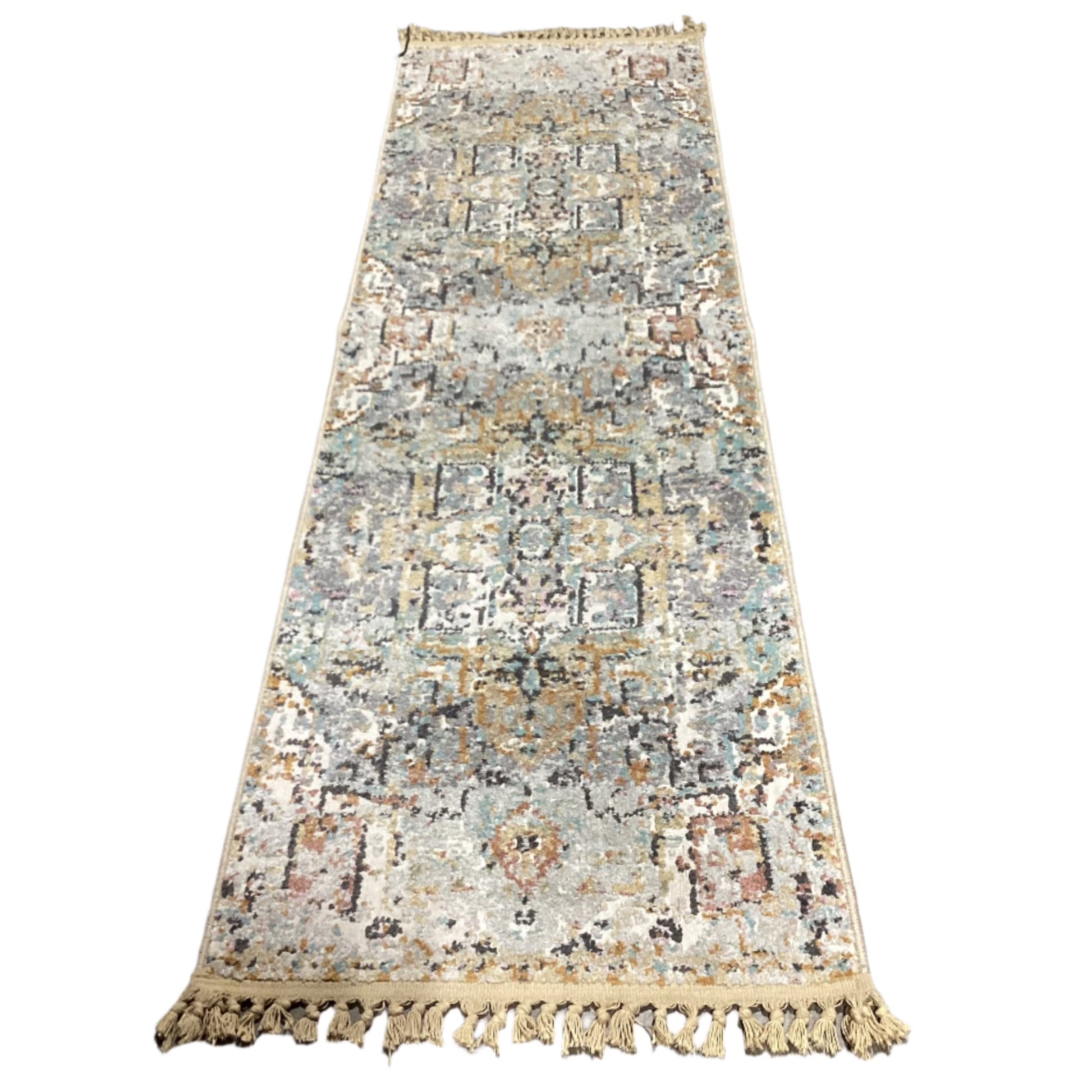 A long rectangular area rug with a distressed traditional pattern in muted beige, cream, light blue, gray, and brown tones, finished with tasseled fringe on both ends.
