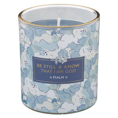 Candle in a floral-patterned container with a motivational quote