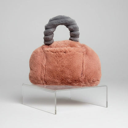 faux fur blush crush pur-low on a product stand