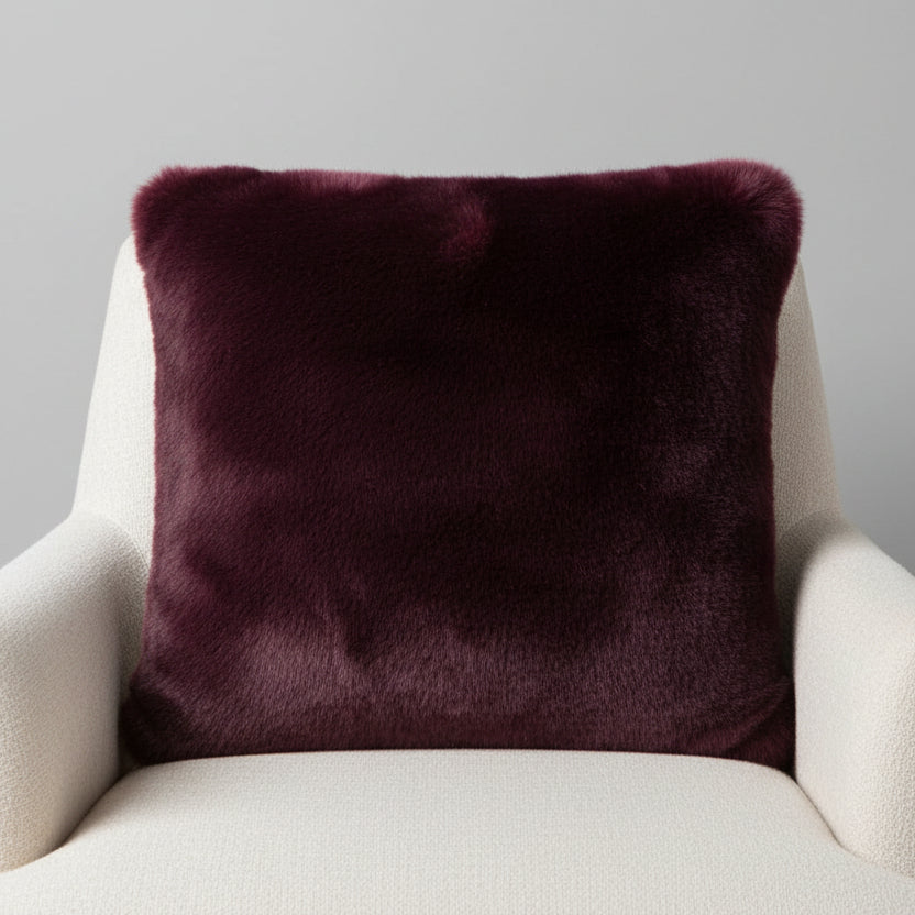 Luxuriously soft faux fur pillow in rich blackberry burgundy. Adds warmth, texture, and bold color to sofas or beds. Open box, final sale.