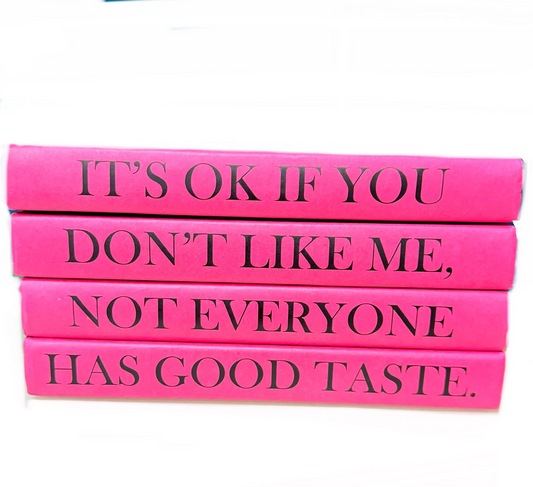 Stack of pink books with black text on a white background