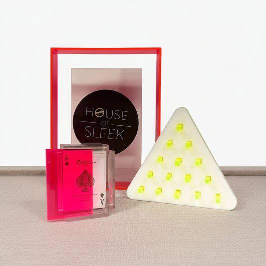 Bicycle playing cards with a red frame and 'House of Sleek' logo, next to a triangular light fixture.