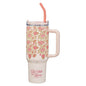 Floral-patterned tumbler with handle and straw on a white background