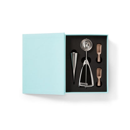 ice cream party set Set of bar tools including a jigger, strainer, and other utensils in a light blue box on a white background.