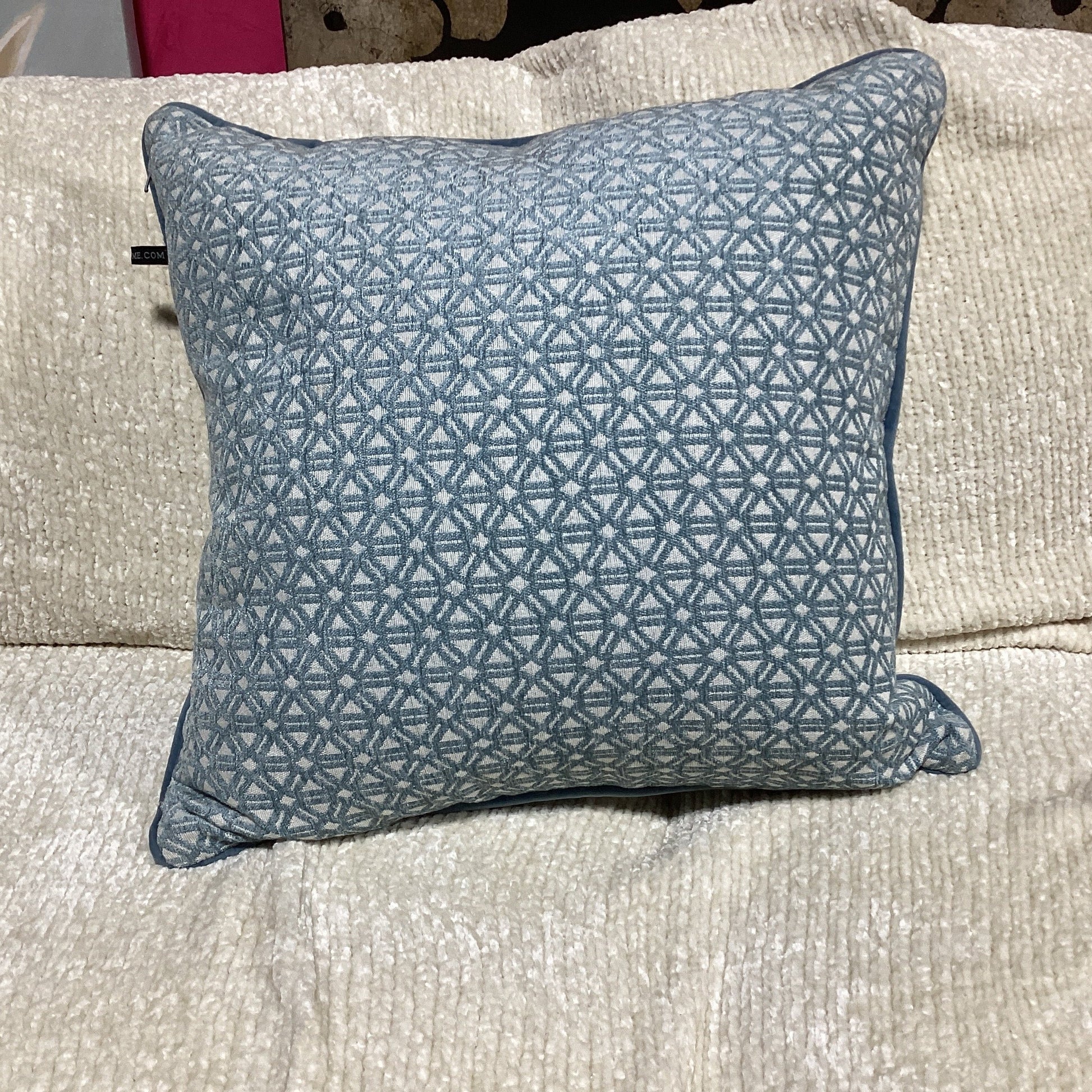 light blue and white decorative pillow