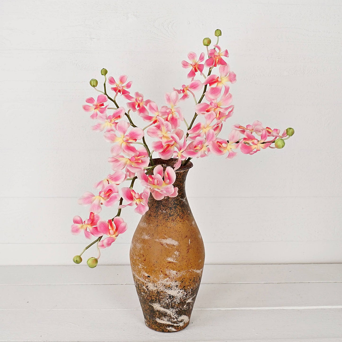 Decorative vase with pink flowers on a white background