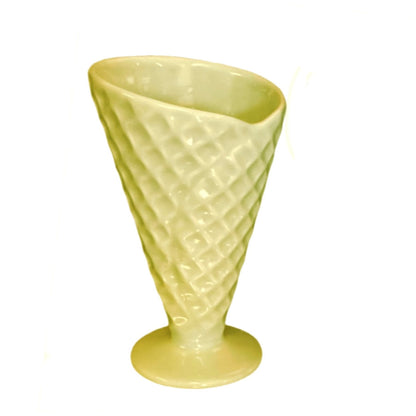 Yellow textured waffle cone on a white background